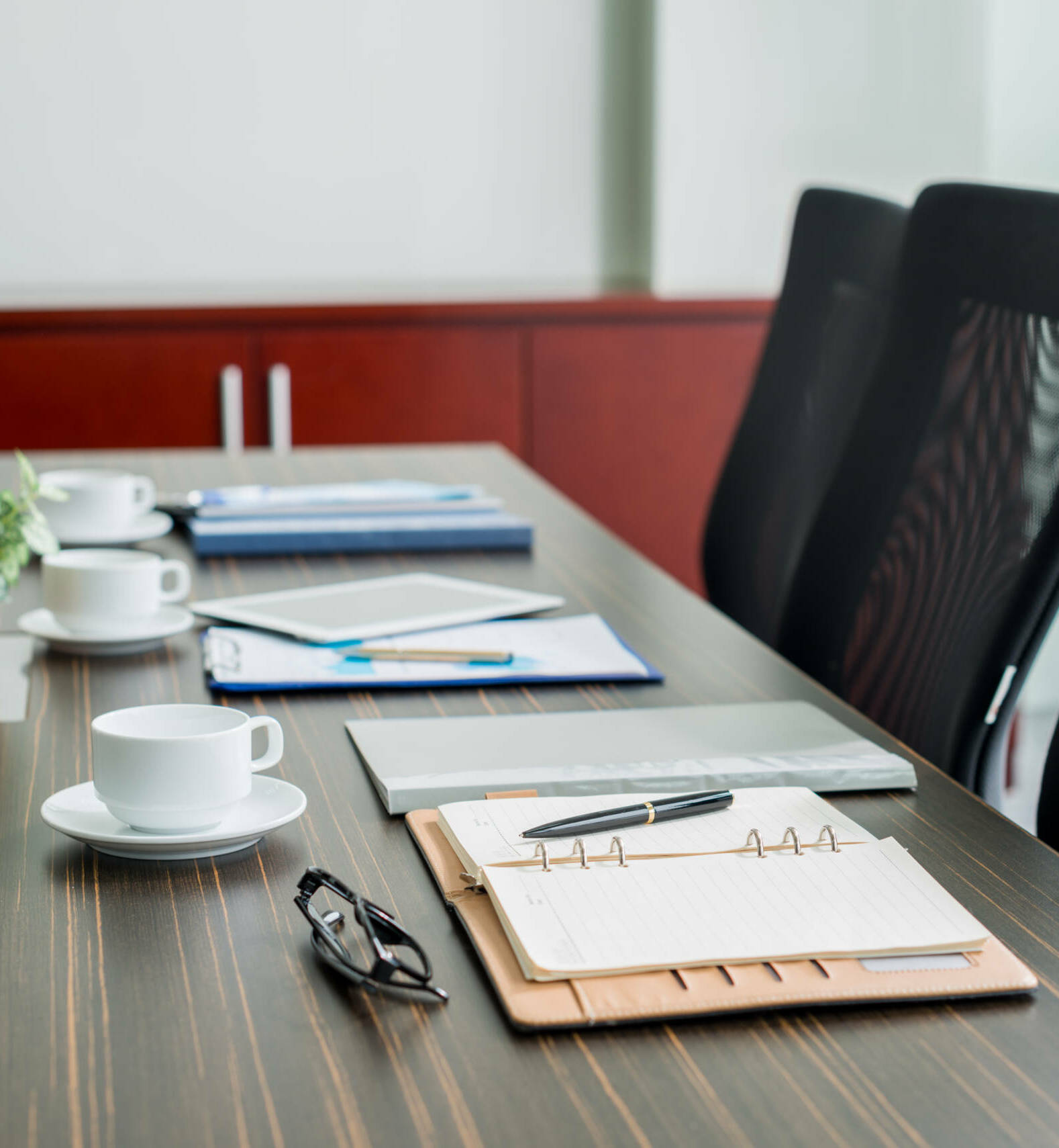 Table with notepads and coffee cups for business meeting
